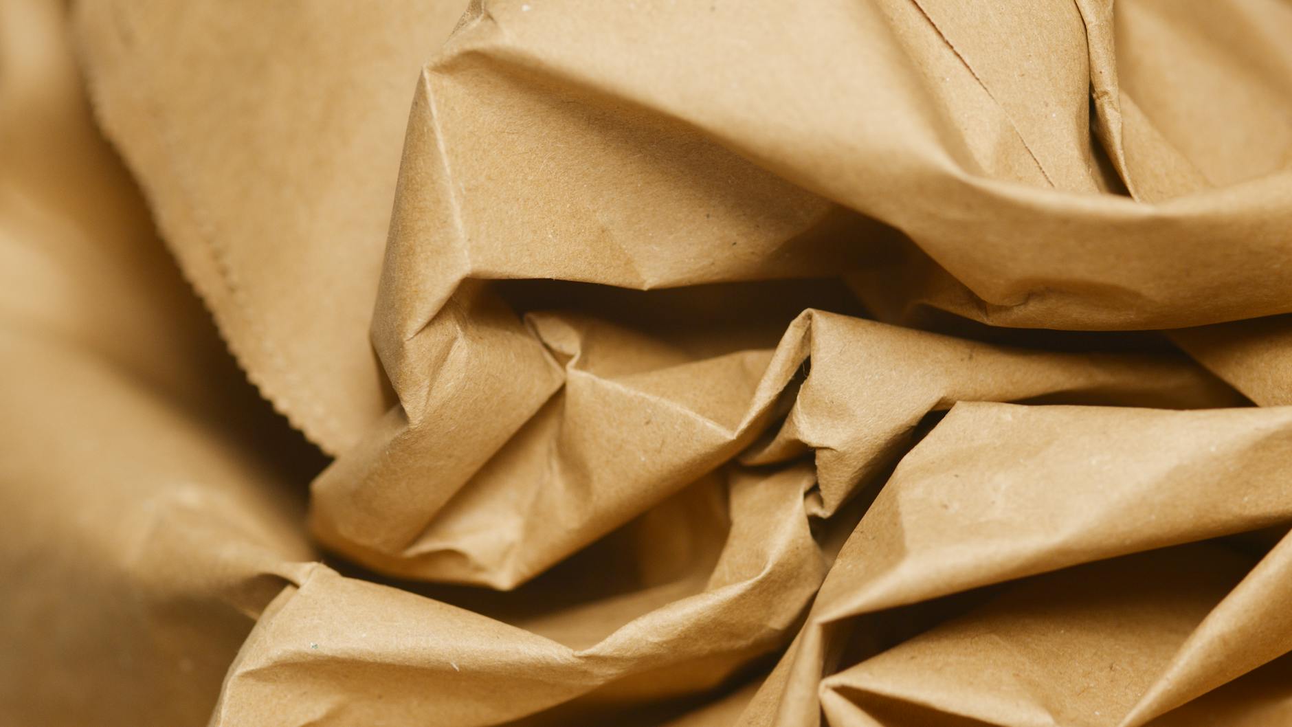 Brown kraft paper texture close-up showing fibre structure