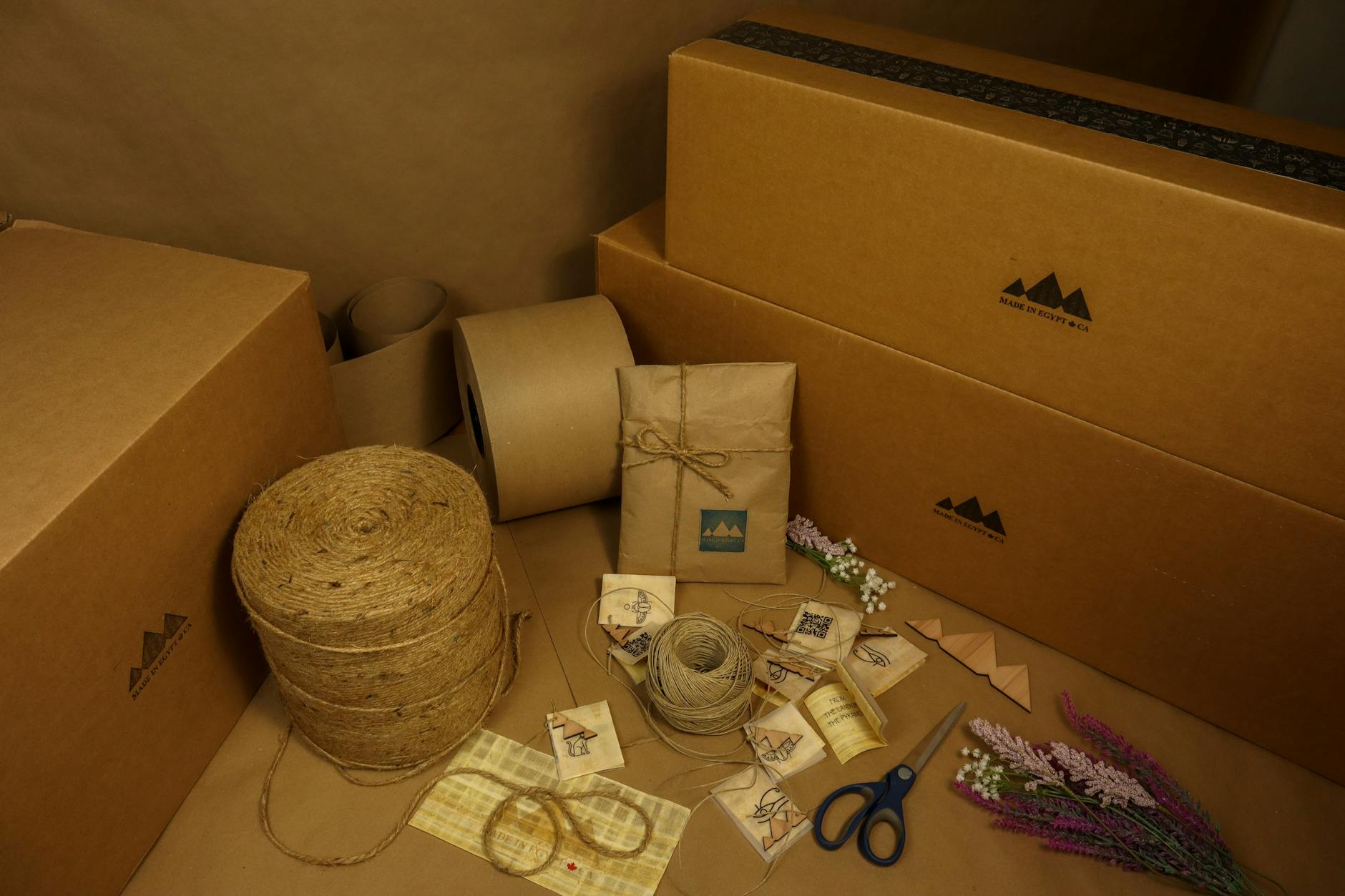 Assortment of kraft paper bags, boxes, and natural twine representing eco-friendly paper packaging materials