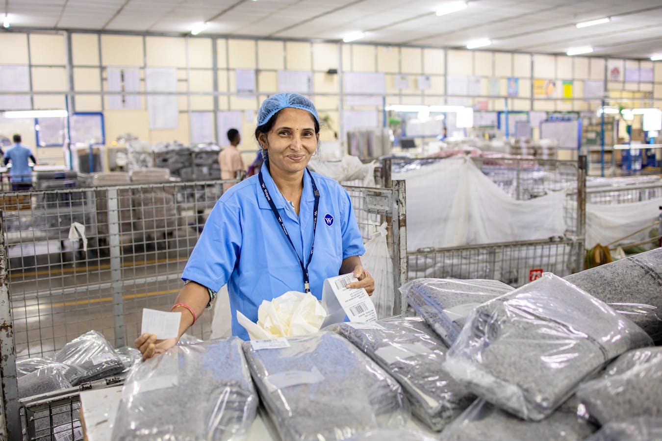 Indian factory worker sorting packaged products: EPR compliance touches every dispatch record