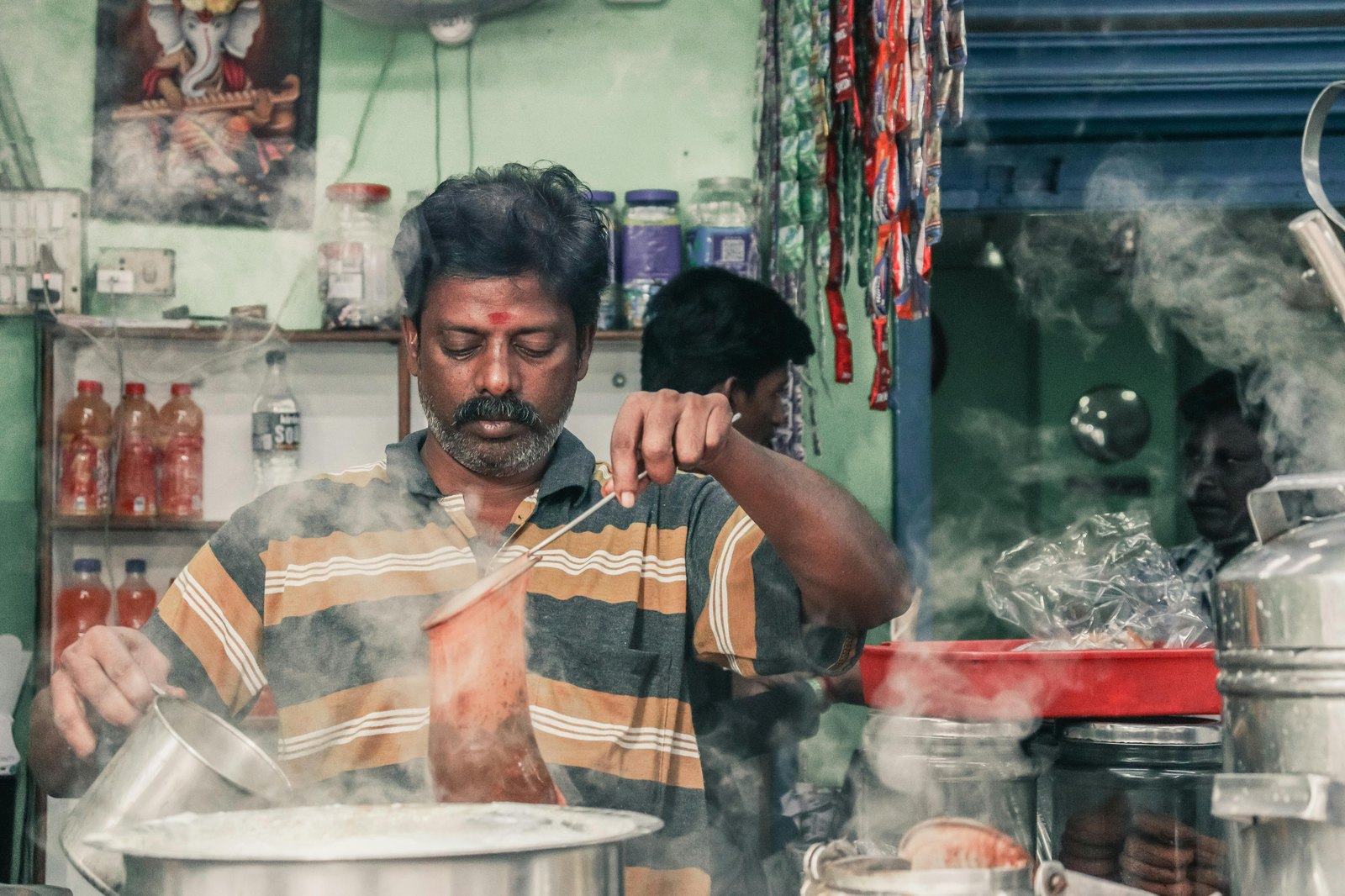 Vendor preparing masala chai at an Indian tea stall