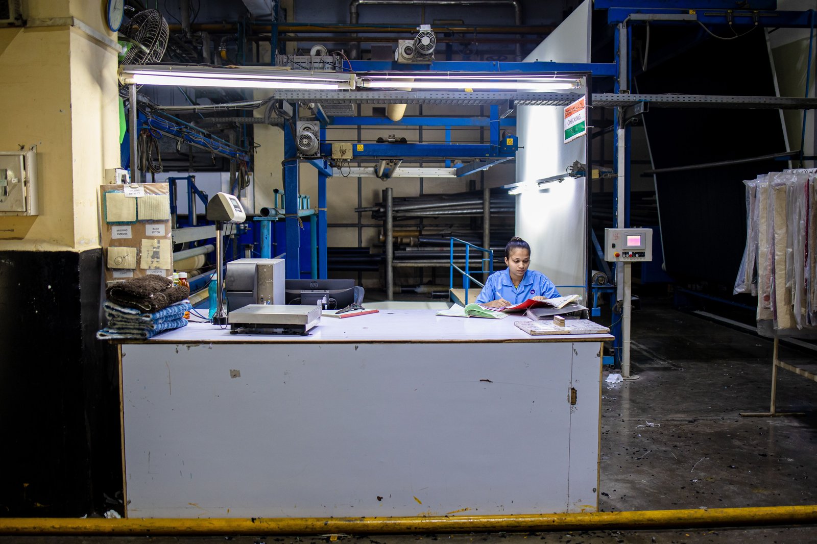 Indian factory worker reviewing specification documents during paper bag supplier qualification