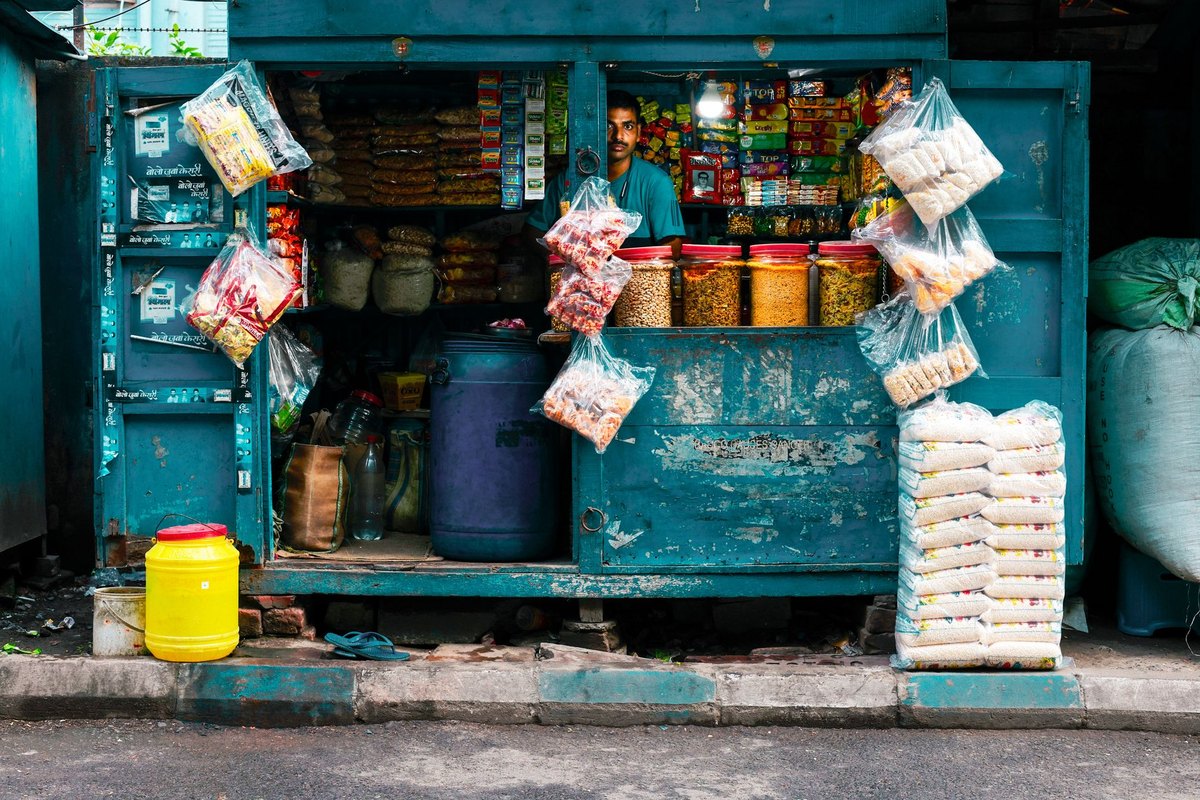 A vibrant tea and grocery street vendor stall in Kolkata, India