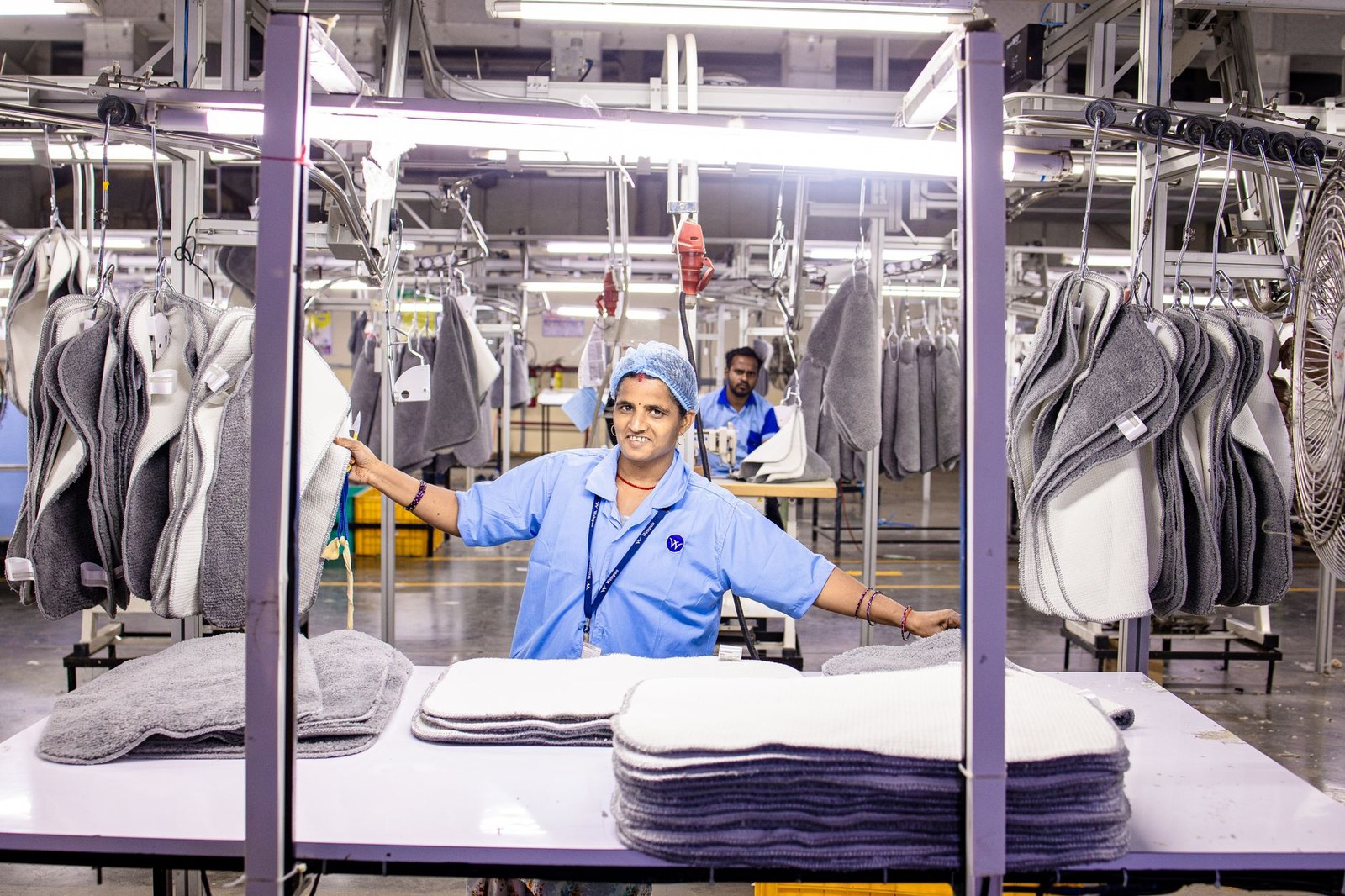 Converting line operator running a precision quality check in an Indian paper bag factory