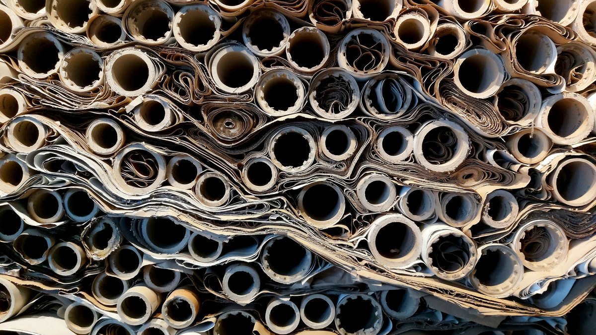Stacked paper reels in warehouse storage, the reel-to-reel consistency a coater checks for air permeability variation
