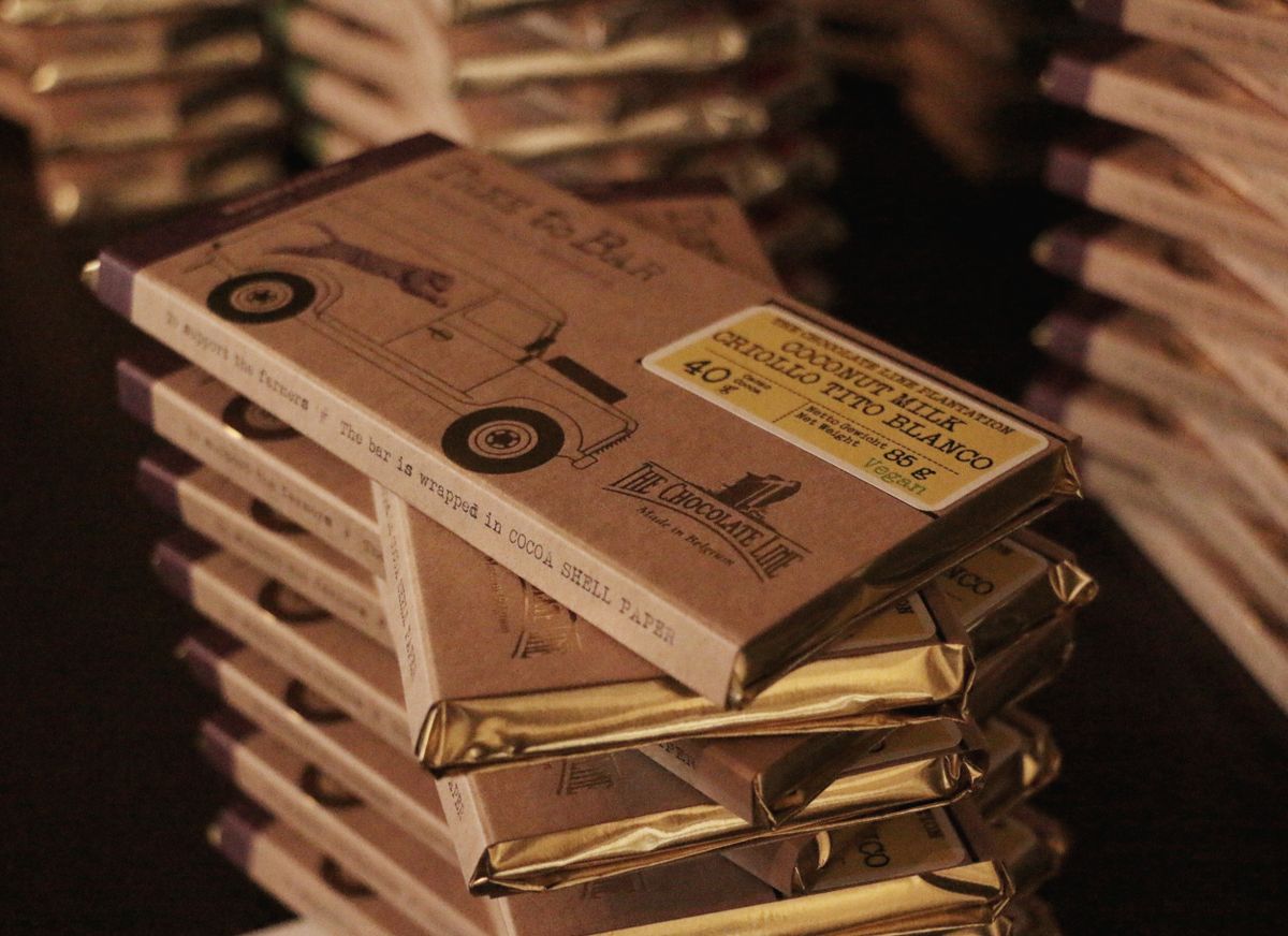 Paper-wrapped chocolate bars on a plain surface illustrating moisture barrier and sugar bloom control