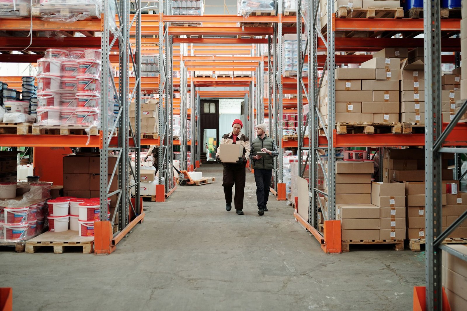 Workers handling packaged cartons for export dispatch in a warehouse