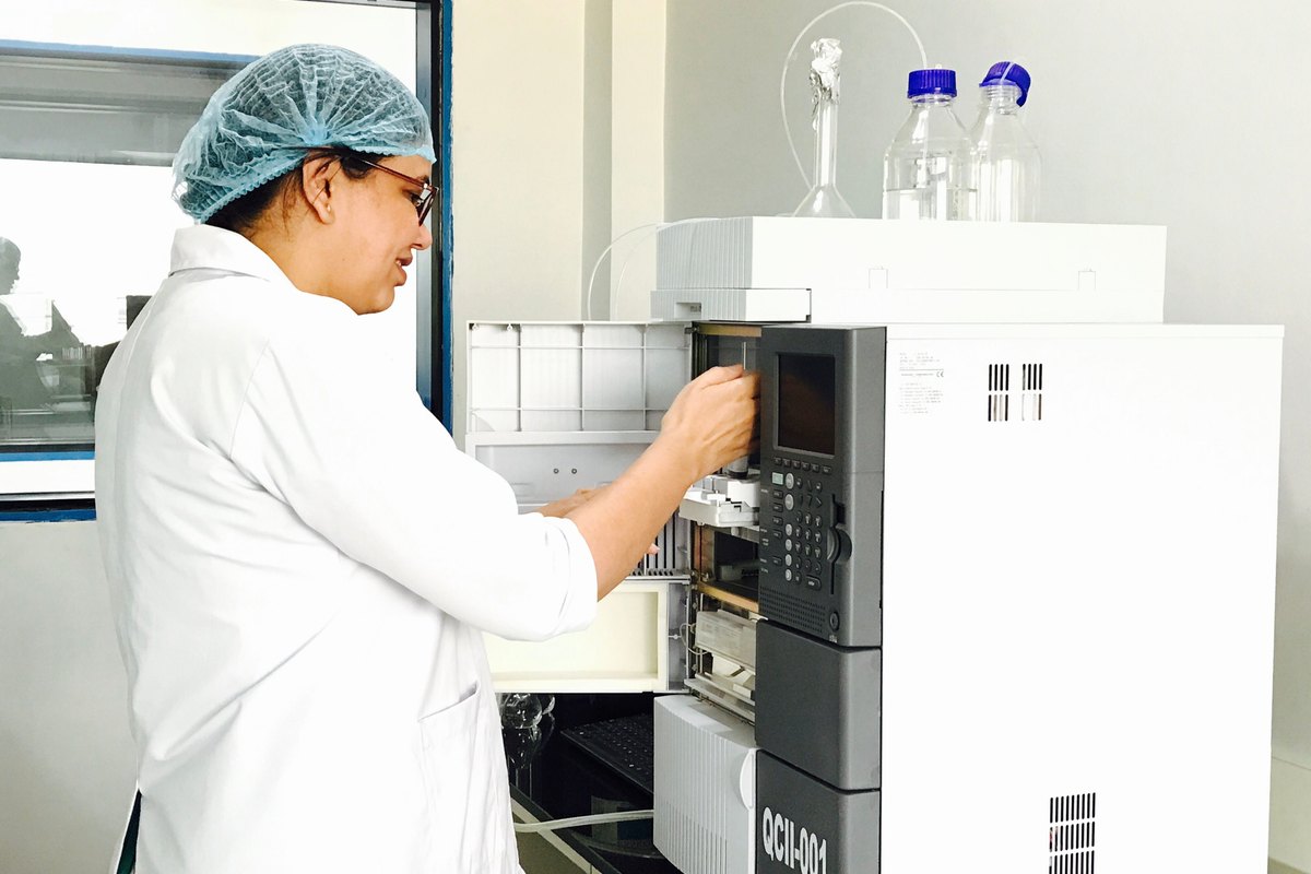 Laboratory technician operating analytical chemistry testing equipment in India