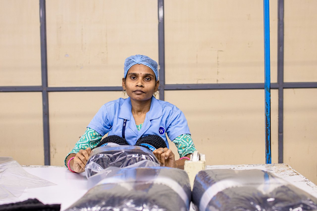 Worker inspecting paper reels on an Indian converting line