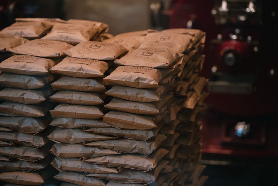 Stacks of printed brown kraft paper bags in an industrial packaging area