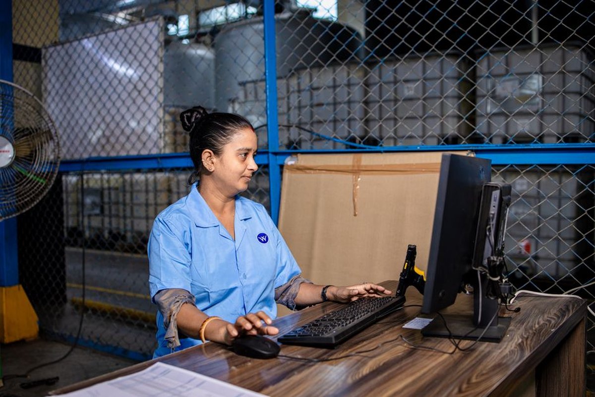 An Indian factory worker enters data at a computer terminal, the kind of screen used to file packaging compliance returns