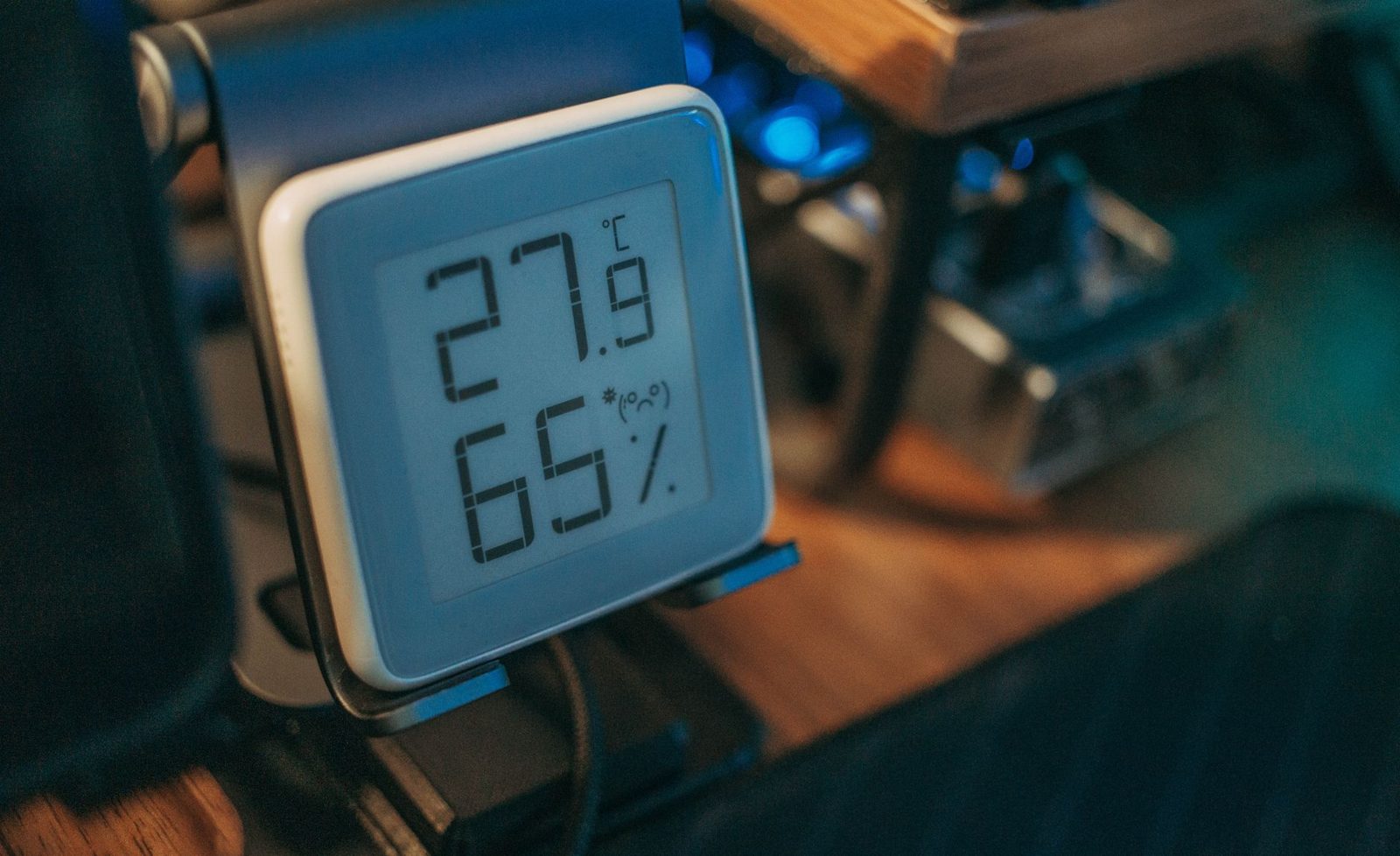 Small digital hygrometer showing 27.9 degrees Celsius and 65 per cent relative humidity on a desk