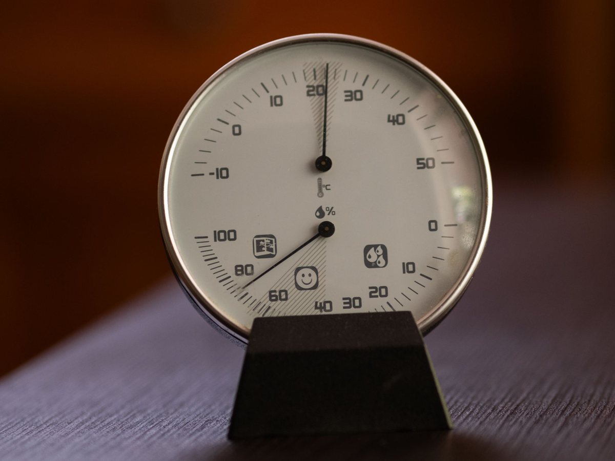Analogue hygrometer dial with the humidity needle reading around 70 per cent