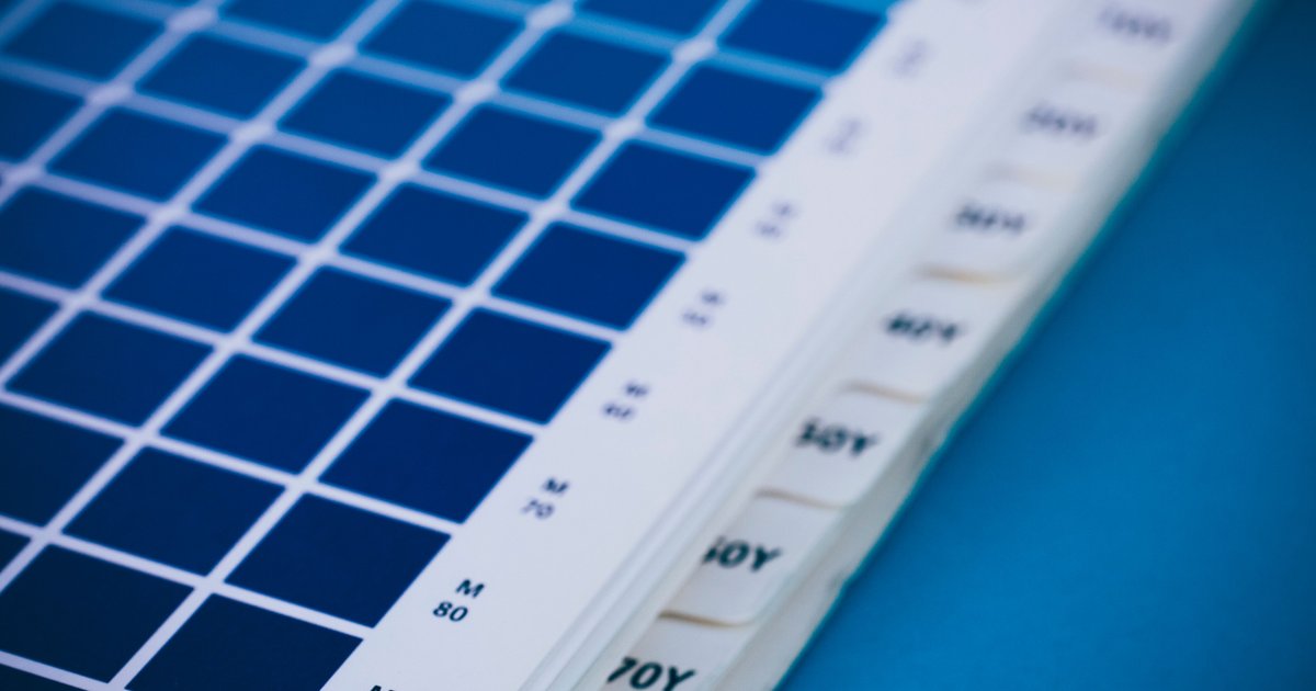 Printed cyan and magenta process colour tint chart on white paper, step values labelled along the edge