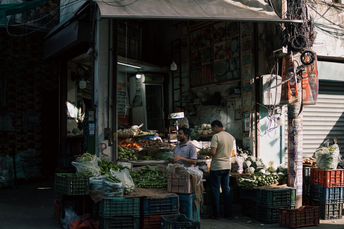 Vegetable shop on a street in Ludhiana, Punjab, with produce in crates and plastic carry bags in use
